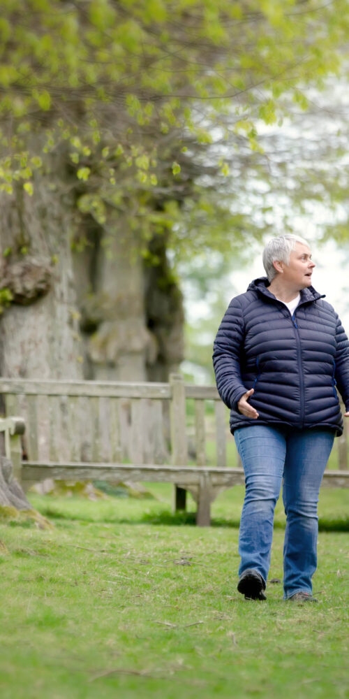Eileen and client walking along a woodland path during a walk and talk therapy session in Stockprot"
